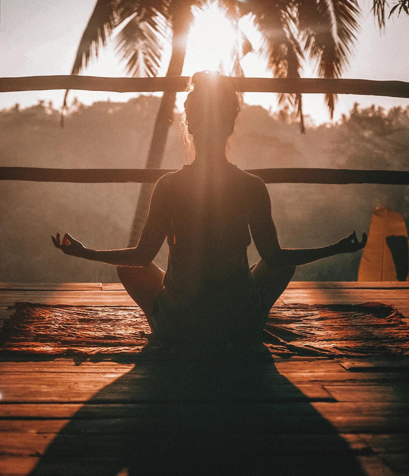woman sitting at dusk practicing yoga