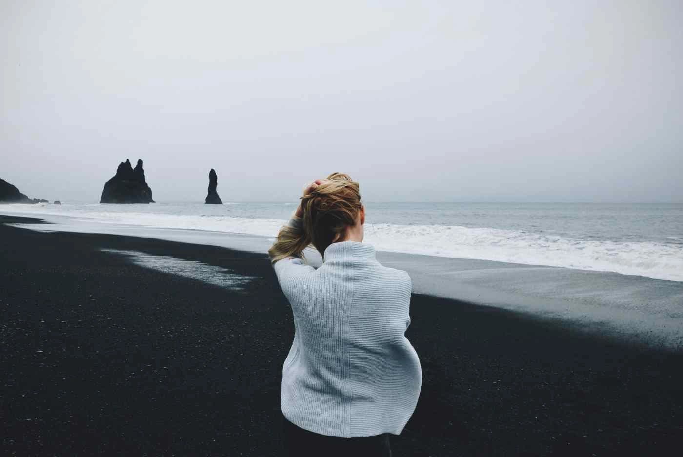 A solitary figure walking through open misted landscape